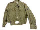 an old military jacket with patches and buttons on the chest