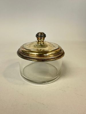 an image of a glass jar with a gold lid on a white surface