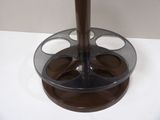 a glass holder with four cups in it on a table