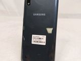 the back of a black samsung phone with a barcode on it
