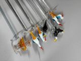 a bunch of glass birds that are hanging on a rack