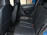 a blue car with black leather seats in the back of it