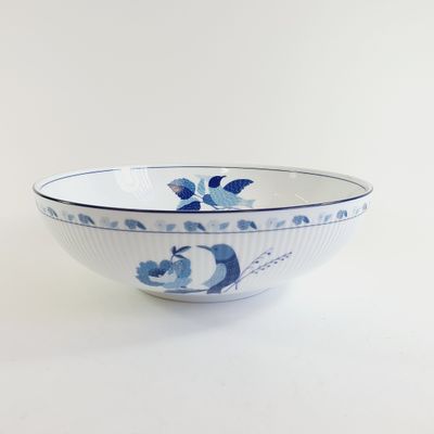 a blue and white bowl sitting on a white table