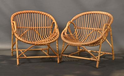 pair of vintage bamboo chairs with woven seats against a gray background