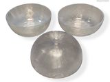 three bowls that are sitting on a white surface