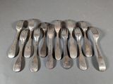a lot of forks and spoons that are on a table