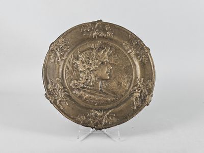 a gold plate with an image of a woman on it