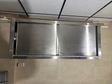 a stainless steel hood above a sink in a bathroom