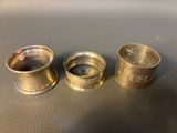 three silver cups sitting on top of a table next to each other
