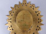 gold plate with a cross and a star on it on a white surface