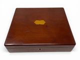 brown wooden box with a gold leaf on the lid