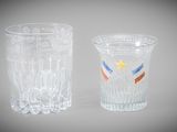 two shot glasses with different designs on them sitting next to each other