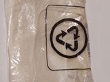 a plastic bag with a sign on it on the wall