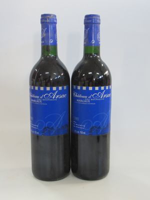two bottles of red wine sitting next to each other on a table