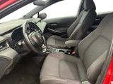the interior of a red car with a steering wheel and dashboard