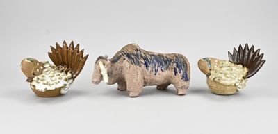 three figurines of animals that are standing next to each other