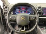 the interior of a car with a steering wheel and dashboard controls