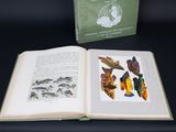 an open book on a table with a picture of fish