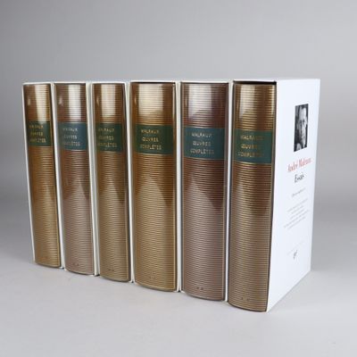 five books in a row in a white box on a table
