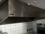 a kitchen with a stove, oven, and sink in it
