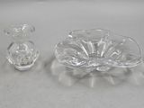 a small glass bowl and a small glass vase on a table