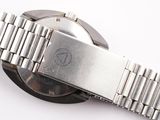 a close up of a watch on a white surface