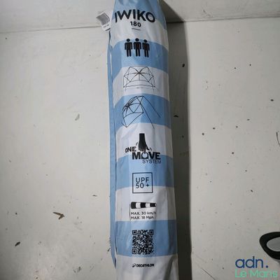 a blue and white umbrella hanging on the wall