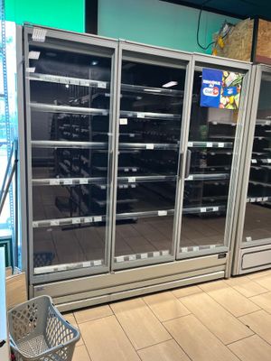 a picture of a refrigerator in a store with its doors open