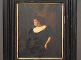 painting of a woman in a black dress on a wooden easel