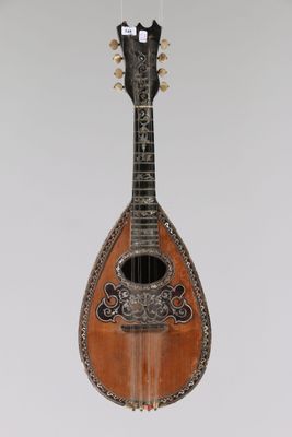 a close up of a mandolin hanging from a string