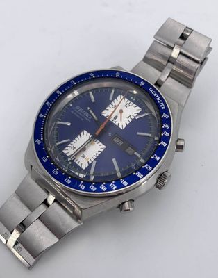 a silver watch with a blue face on a white surface
