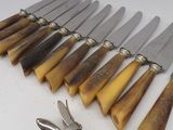 a lot of knives that are laying on a table