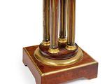 a clock that is sitting on top of a wooden stand