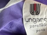 a close up of a label on a purple shirt