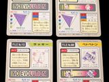 four cards with different designs on them sitting on a table
