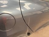 a close up of a car ' s door handle with a sticker on it