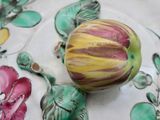 a plate with a painted egg on it on a table