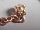 a close up of a gold chain with a clasp on it