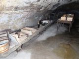 a long wooden bench in the middle of a cave