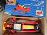 a box with a toy car in it on the floor