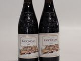 two bottles of wine sitting next to each other on a table