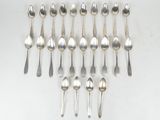 a group of silver spoons and spoon spoons on a white surface