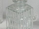 three glasses and a decanter sitting on a table