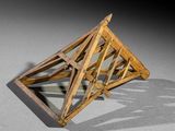 a wooden structure that is sitting on the ground