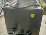 a stainless steel counter top with a sink and a faucet on it