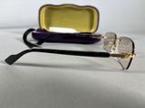 purple and gold eyeglass case and glasses on a white surface