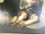 un tableau représentant un homme assis par terre