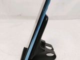 a cell phone that is on a stand on a table