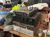 a lot of electronics on a table in a room