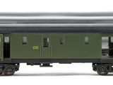 three green train cars sitting side by side on a white surface